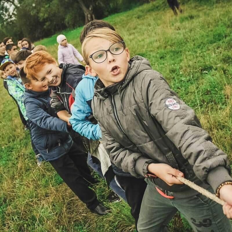 group of children pulling brown rope